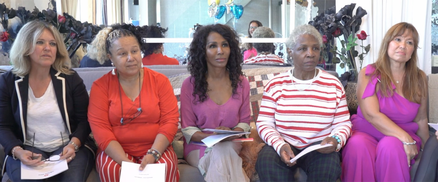 5 woman sat on a sofa listening
