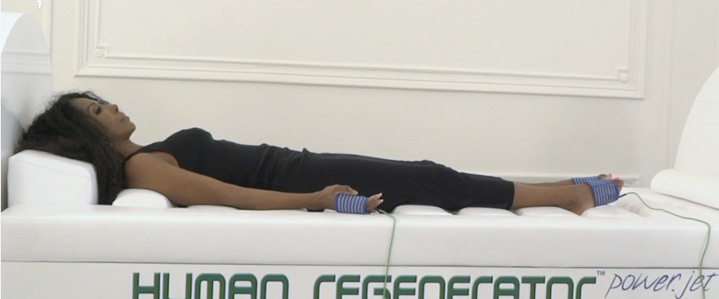 woman lying on human regenerator machine
