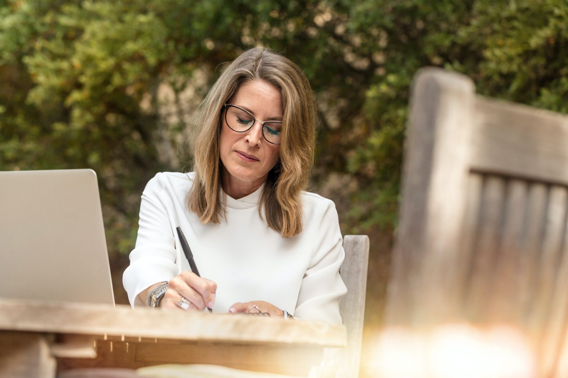 Older woman writing on paper