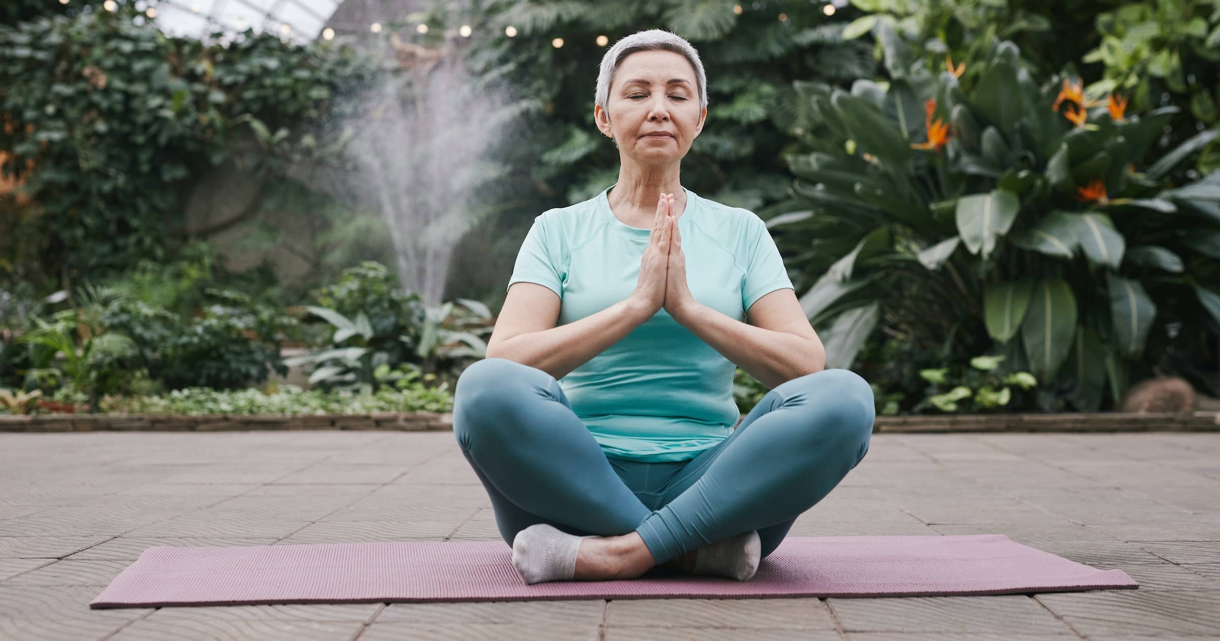 Senior woman holding lotus position
